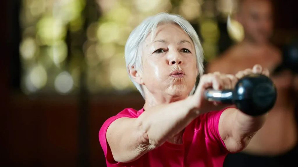 Toning Arms Without the Bulk: Is It Achievable? 1 Woman doing resistance band exercises for toned arms Beaconsfield